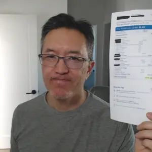 Me holding my Mom's insane cable TV bill