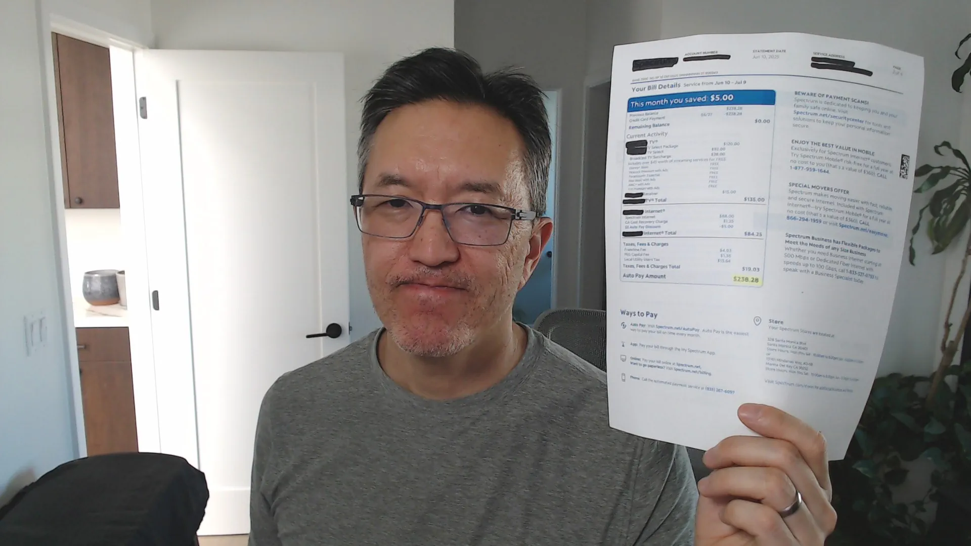 Me holding my Mom's insane cable TV bill